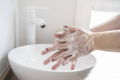 Close-up of woman washing her hand with soap - SNF00026