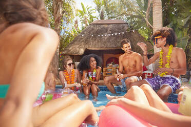 Young friends hanging out in sunny summer swimming pool - CAIF27221