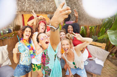 Enthusiastic young friends taking selfie at sunny summer poolside - CAIF27227