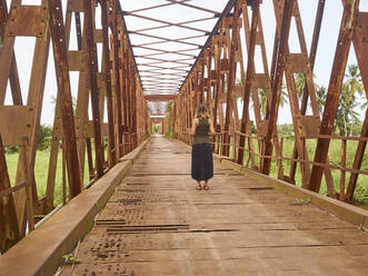 Benin, Departement Mono, Grand-Popo, Frau steht in der Mitte einer alten Eisenbrücke - VEGF02140