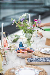 Bowl of food arranged on table during party at building terrace - MASF18266