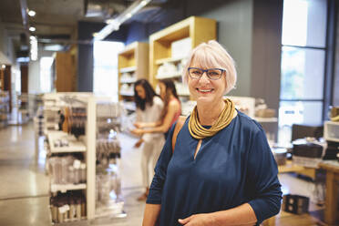 Portrait smiling confident senior woman shopping in home goods store - CAIF27483