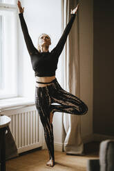 Frau übt Yoga zu Hause - DAWF01417