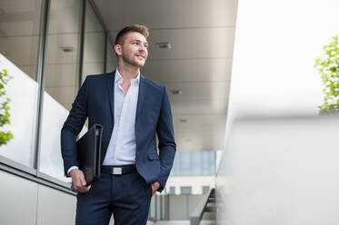 Confident young businessman in the city on the go - DIGF10428