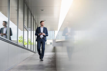 Young businessman with cell phone in the city on the - DIGF10431