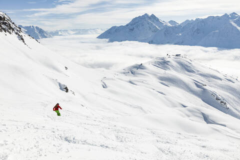 Austria, Vorarlberg, Man skiing in Arlberg massif stock photo