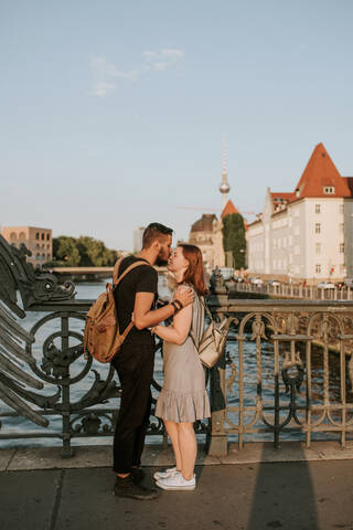 Affectionate young couple on a bridge in the city, Berlin, Germany stock photo
