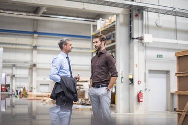 Two businessmen talking in a factory - DIGF10560