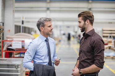 Two businessmen talking in a factory - DIGF10562