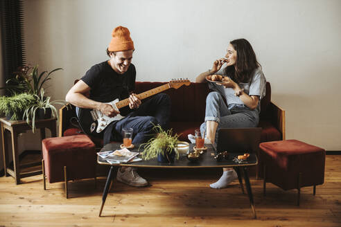 Couple relaxing together on the couch at home - DAWF01487