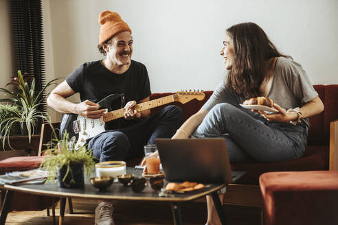 Couple relaxing together on the couch at home - DAWF01488