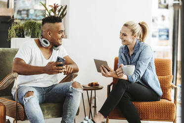 Couple using electronic devices at home - DAWF01506