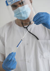 Man in protective wear taking a covid-19 swab - SNF00142