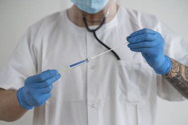 Man in protective wear taking a covid-19 swab - SNF00143