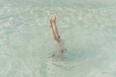 Legs of woman in a pool - ERRF03720