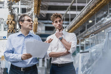 Two businessmen having a meeting in a laundry shop - DIGF10722