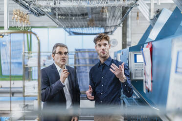 Two businessmen discussing in a factory - DIGF10727