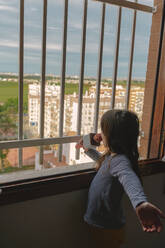 Girl singing at open window - ERRF03743