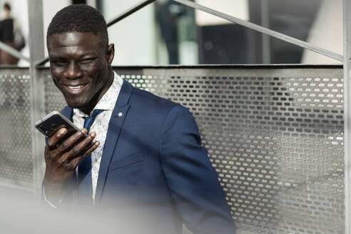 Portrait of smiling businessman using mobile phone - EGAF00068