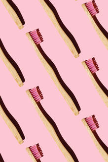 Digitally generated pattern with bamboo toothbrushes on pink background - GEMF03720