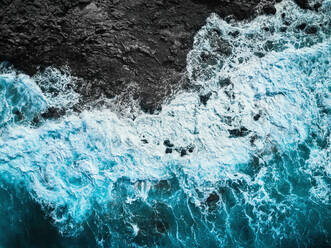 Aerial view of the rough waters hitting the lava reef in Famara, Lanzarote, Spain. - AAEF08362