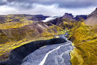 Aerial view of the glaciers at ice-covered volcano Oraefajokull, Iceland. Rivers coming from the glacier modelled deep valley in the foreground. - AAEF08528