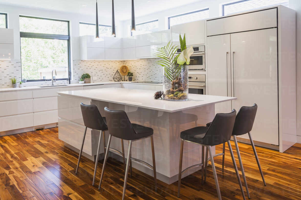 Modern white kitchen with breakfast bar and gothic style window