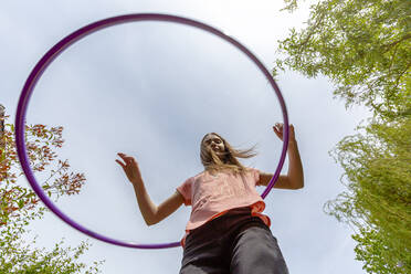 Girl with hula hoop in garden - SARF04579