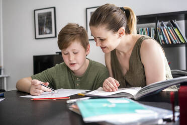 Mother homeschooling her son at home - VPIF02439