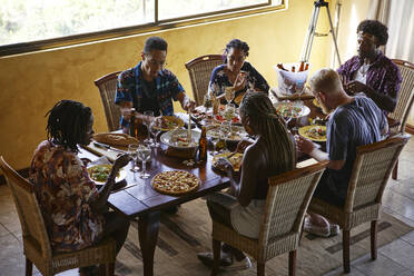 High angle view of friends enjoying lunch while sitting at dining table - VEGF02208