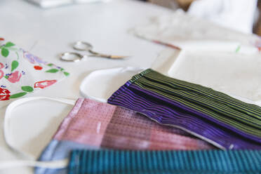 Colorful homemade face masks on table at home - MRAF00516