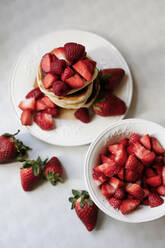 Overhead view of pancakes with strawberries and raspberries and maple syrup - VBF00048