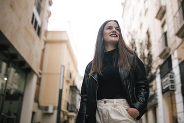 Portrait of happy young woman in the city - GRCF00235