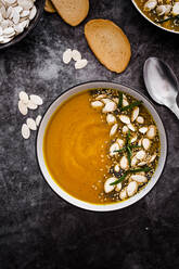 Overhead view of pumpkin soup with seeds - GIOF08173