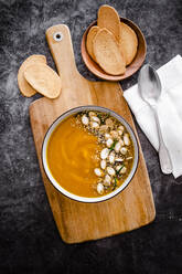 Overhead view of pumpkin soup with seeds - GIOF08176