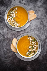 Overhead view of pumpkin soup with seeds - GIOF08177