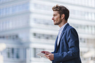 Young businessman using tablet in the city - DIGF10911