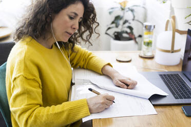 Woman working at desk in home office - ERRF03762