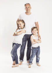 Portrait of father with two children standing in front of white background - SDAHF00953