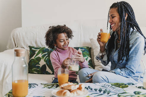 Happy mother and her little daughter drinking smoothie and juice at home - EBBF00012