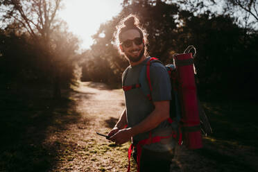 Bearded man with smartphone on a hiking trip - EBBF00021