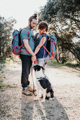 Couple with dog on a hiking trip - EBBF00026