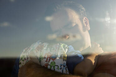 Portrait og man with eyes closed hugging his little daughter at home - VABF02940