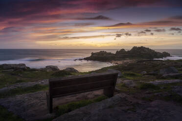 Bench with wonderful views of some ancient ruins on the coast - CAVF80923