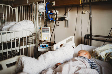 Baby child sick at the hospital with a virus coronavirus - CAVF80982
