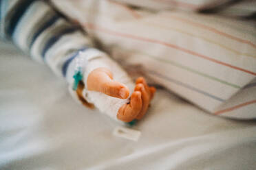 Baby child hand with IV sick at the hospital with a virus coronavirus - CAVF80987