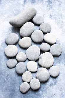 Grey and white pebbles on a grey background. - CUF55113