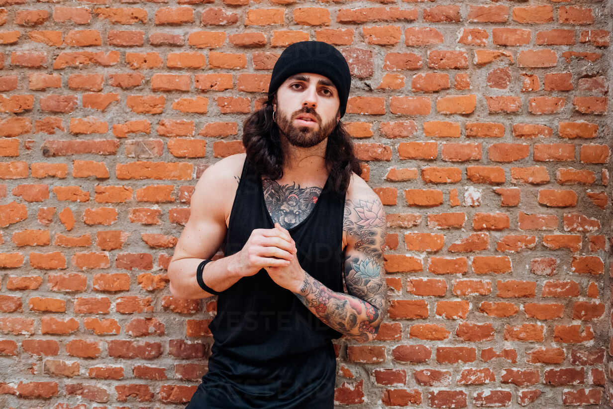 Young Man With Large Tattoo Against Old Brick Wall Stock Photo - Download  Image Now - iStock
