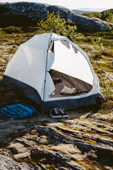 Camping tent set on a rocky terrain - CAVF81062