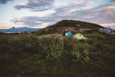 Man walking in a camp site set in a mountain top - CAVF81078